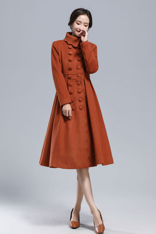 Woman wearing caramel princess wool coat with fitted waist and full skirt