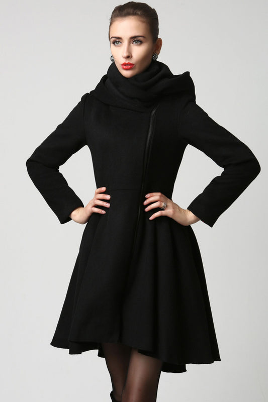A woman modeling a black winter hooded wool coat with a high neck and long sleeves.