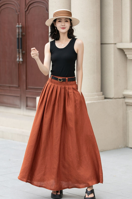 May include: A rust-colored maxi skirt with a black belt and a black tank top.