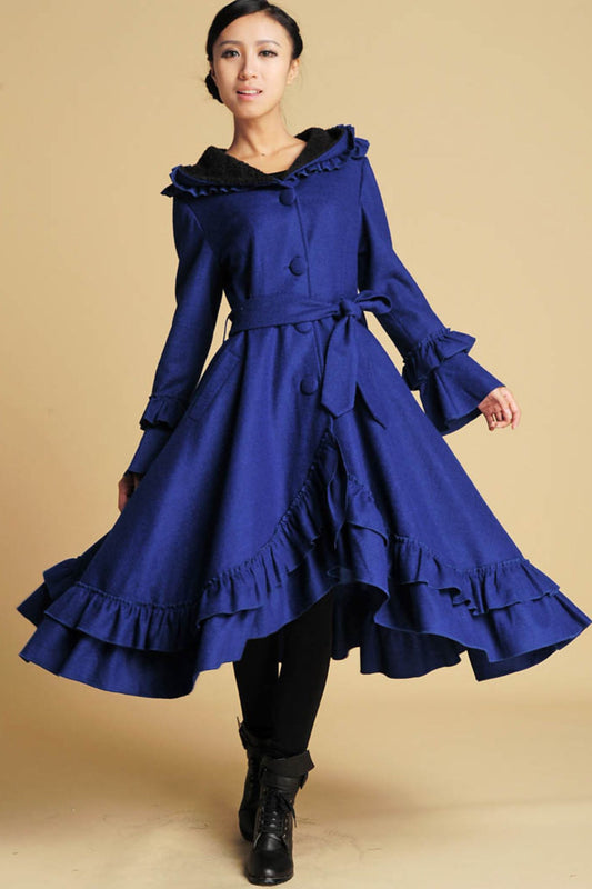 Model wearing royal blue wool maxi coat with hood and ruffle details in winter style