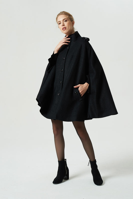 Woman wearing black wool winter cape coat with stand collar and button front