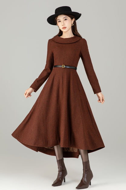 Woman wearing a brown dress with a belt and boots on a gray background