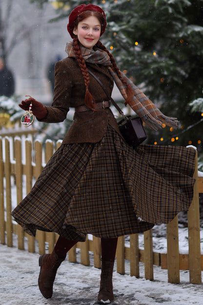A woman wearing a midi wool plaid circle skirt with a classic red and black checkered pattern, paired with a brown coat, black boots, and a pleated skirt. She is standing outdoors in a snowy setting.