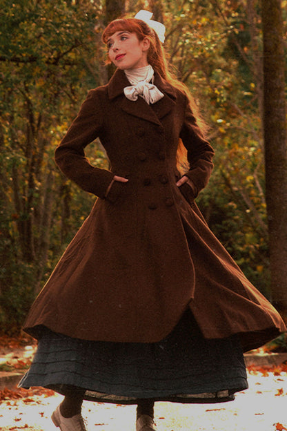 woman wearing vintage brown double-breasted wool maxi coat in autumn park