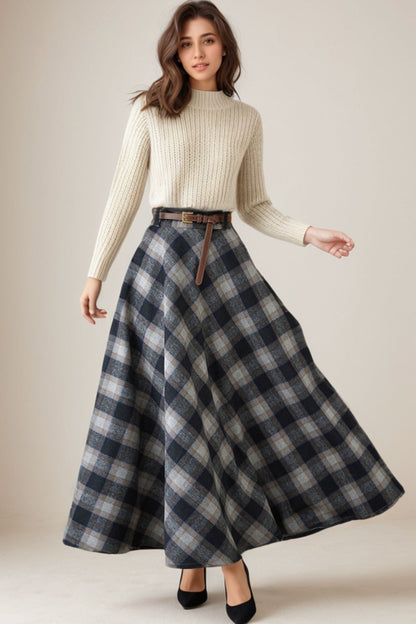 Woman wearing a cream sweater and plaid skirt on a beige background