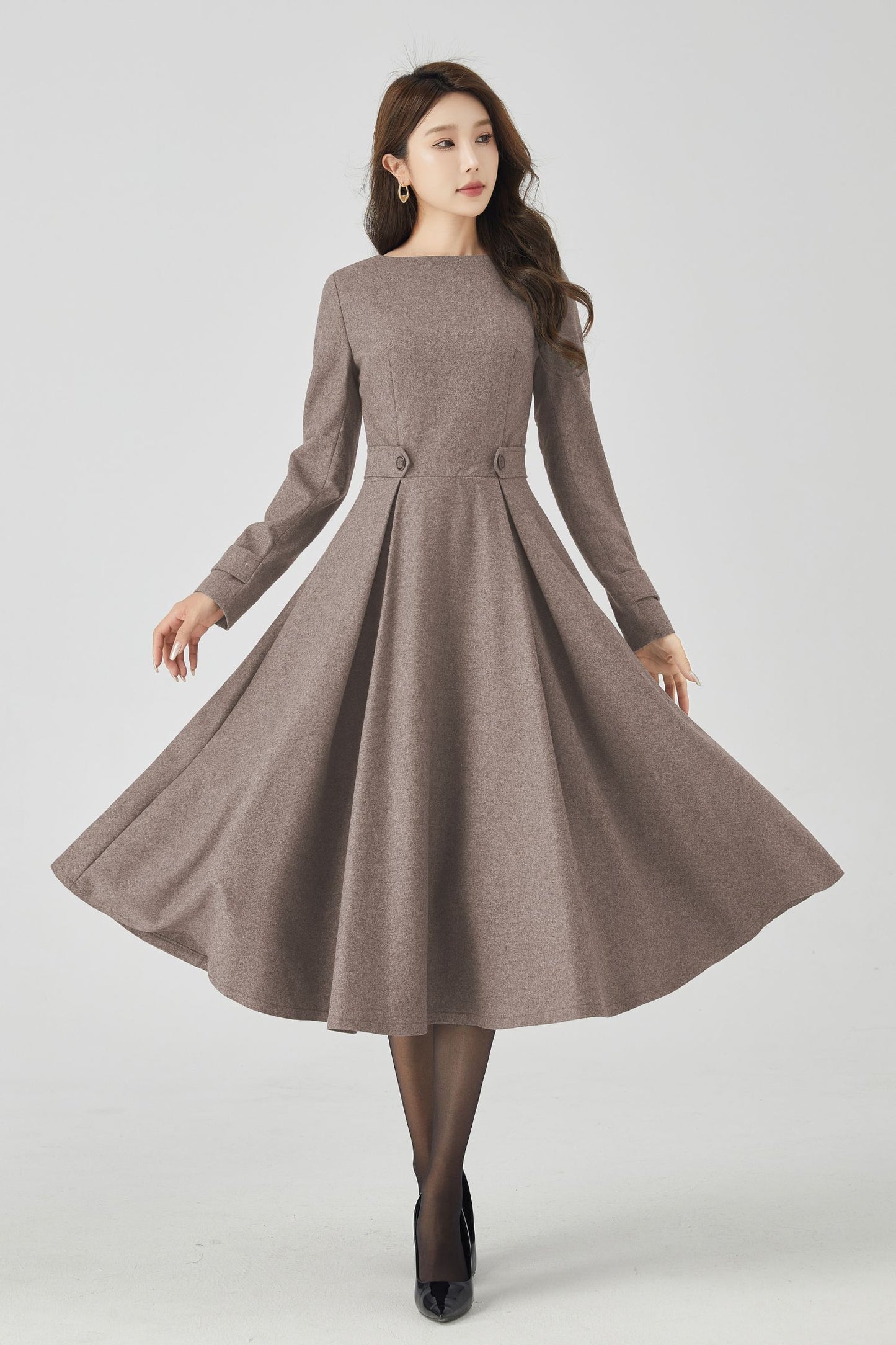 Woman wearing a brown dress on a white background