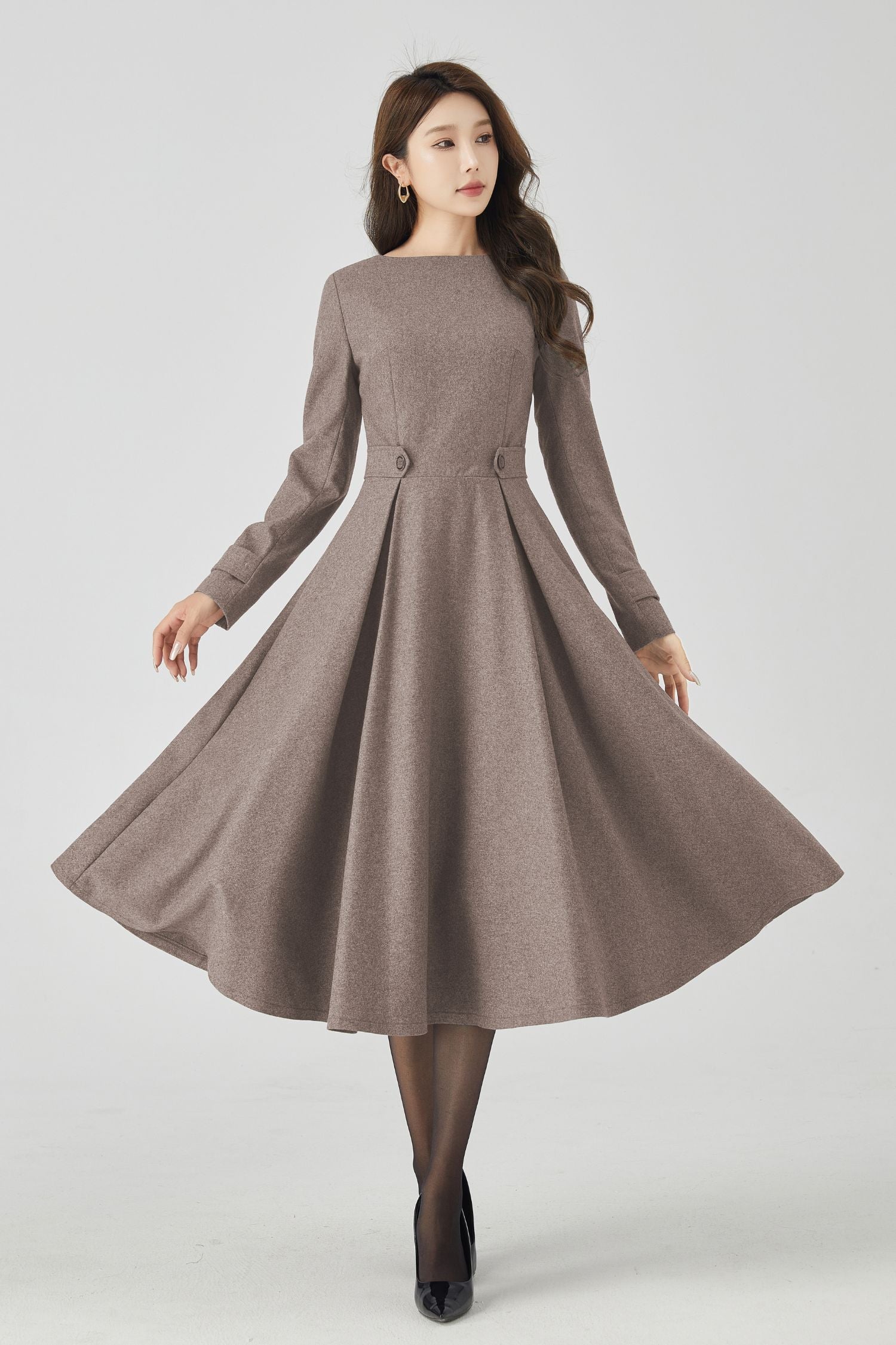 Woman wearing a brown dress on a white background