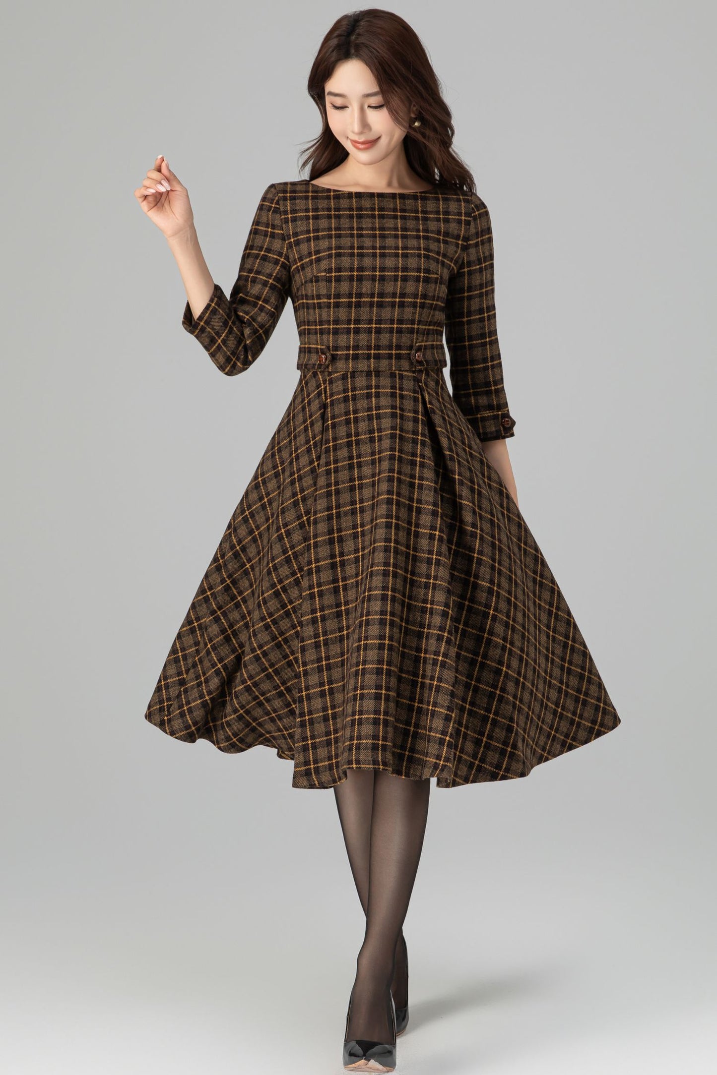 Woman wearing brown plaid wool fit-and-flare midi dress with 3/4 sleeves