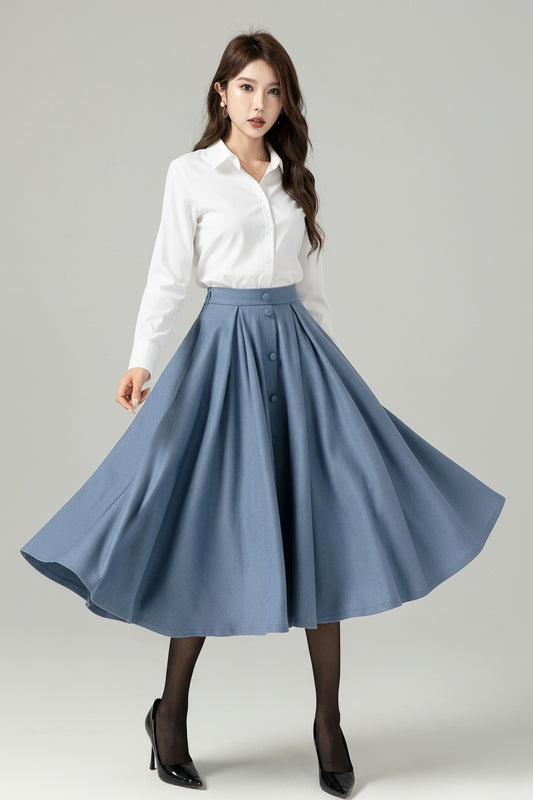 Woman wearing a white blouse and blue skirt on a gray background