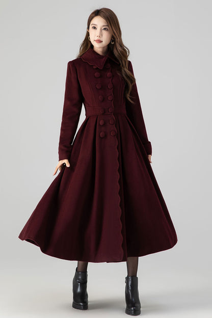 Woman wearing burgundy princess wool coat with pleated front and full skirt