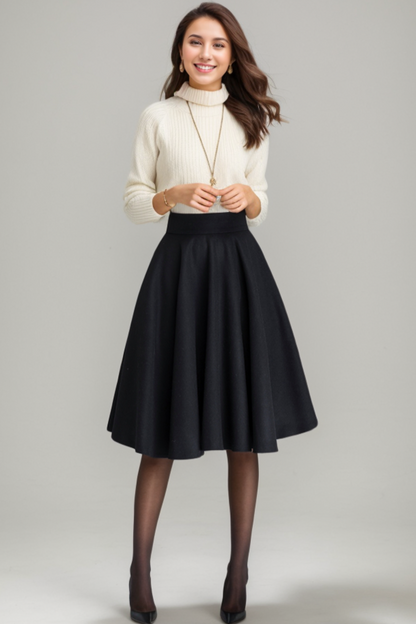 Woman wearing a white sweater and black skirt on a gray background