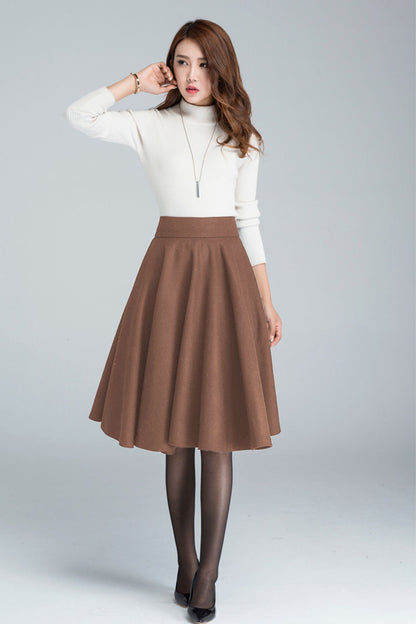Woman wearing a wool skater skirt with side pockets and a back zipper in brown