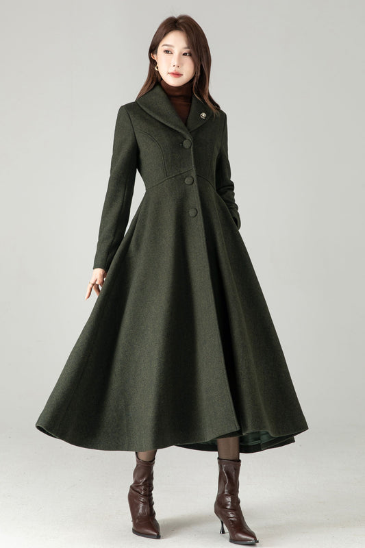 Woman wearing a long dark green coat on a gray background