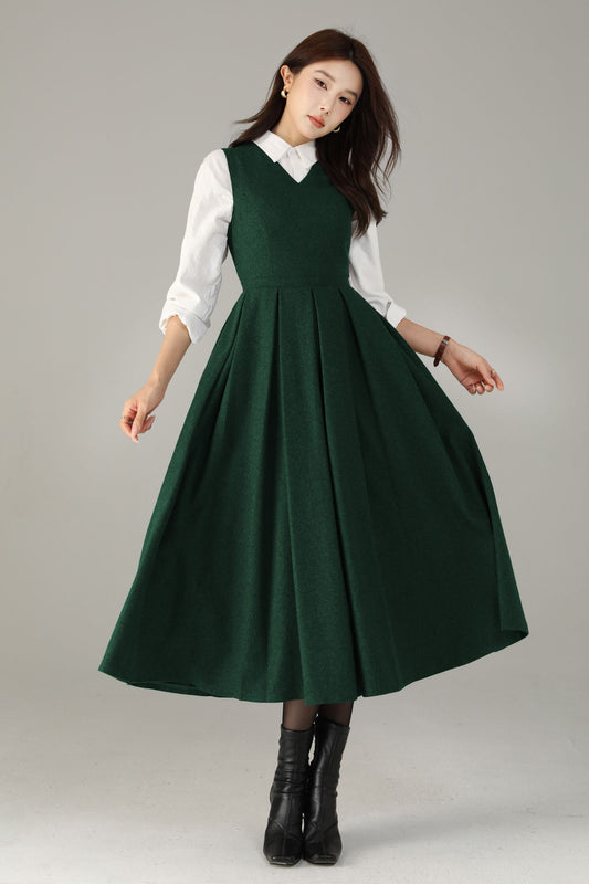 Woman wearing a green dress over a white shirt on a gray background