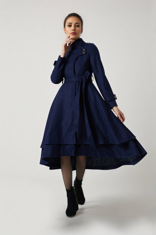 Woman wearing a navy blue coat with a white background