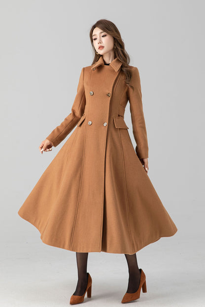 A woman modeling a brown, vintage inspired winter long wool coat with a round neckline, button closure, and two side seam pockets. The coat is double-breasted and the model is wearing high-heeled shoes.