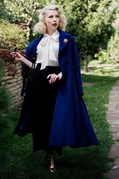 Elegant blue winter overcoat styled with pleated details