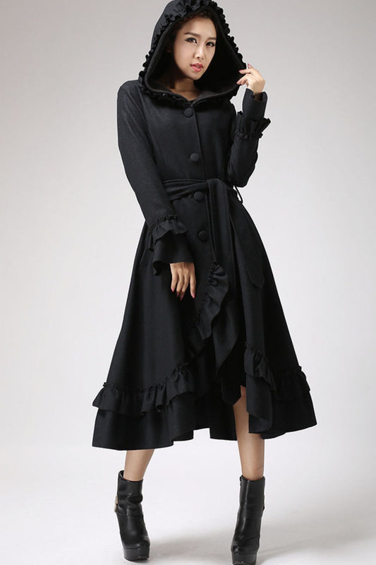 Woman wearing black hooded wool maxi coat with ruffle hem and belt