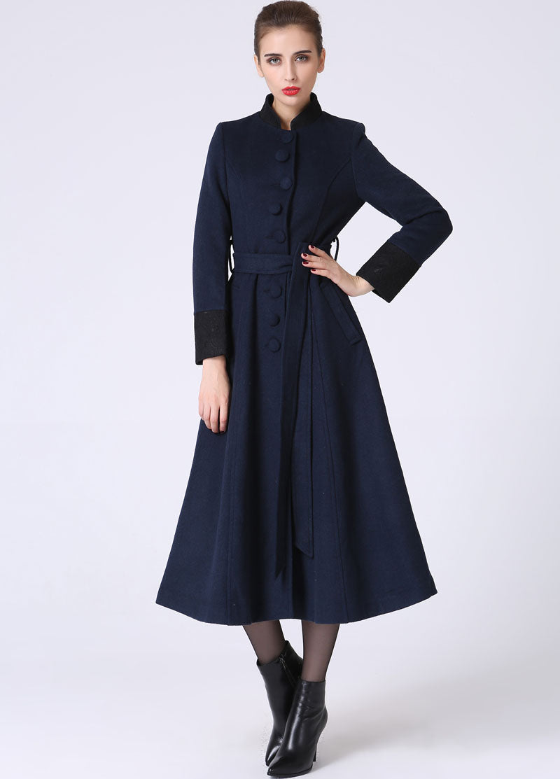 Woman wearing a navy blue coat on a white background