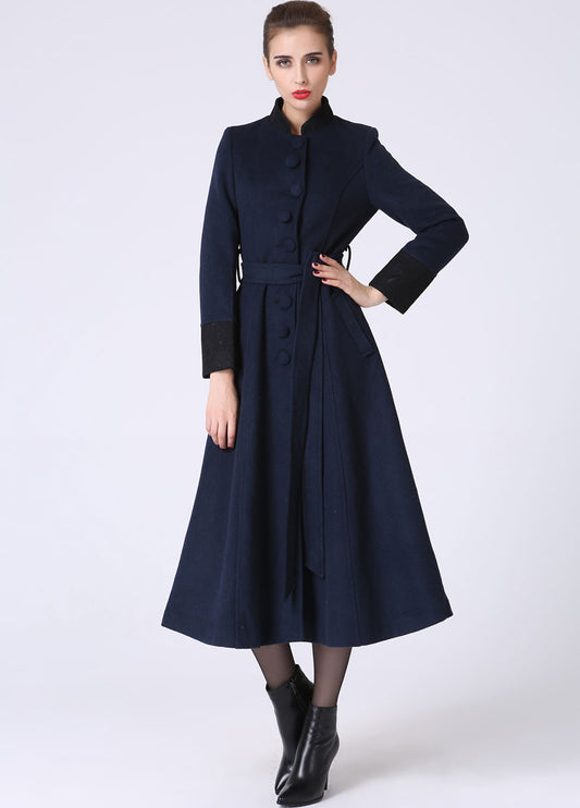Woman wearing a navy blue coat on a white background