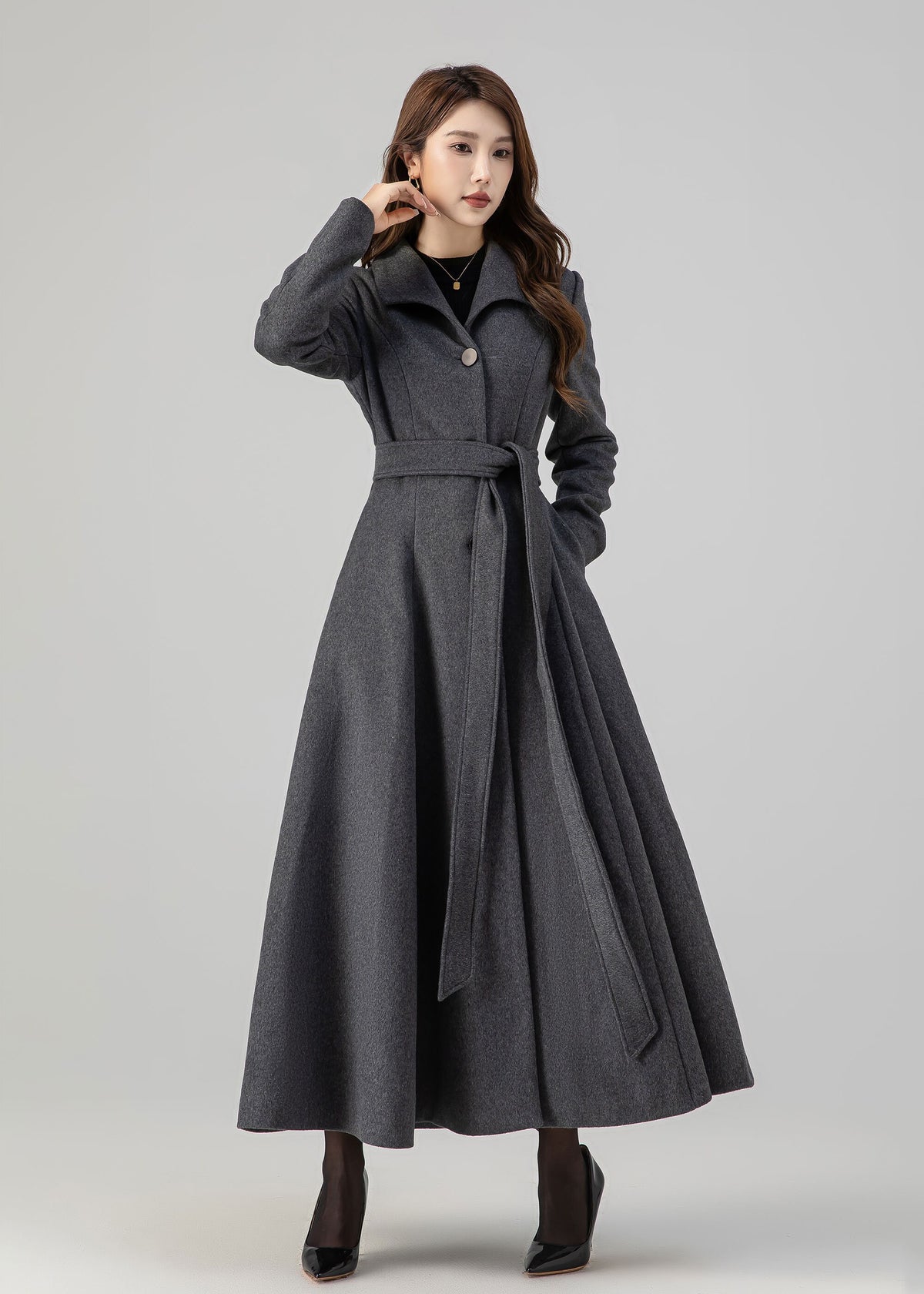 May include: A long gray coat with a belt and a single button closure. The coat has a flared skirt and a collar.