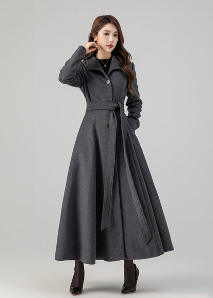 May include: A long gray coat with a belt and a single button closure. The coat has a flared skirt and a collar.