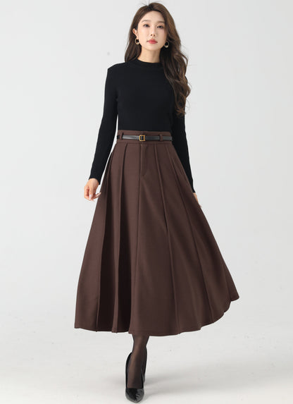 Woman wearing a black top and brown skirt on a white background
