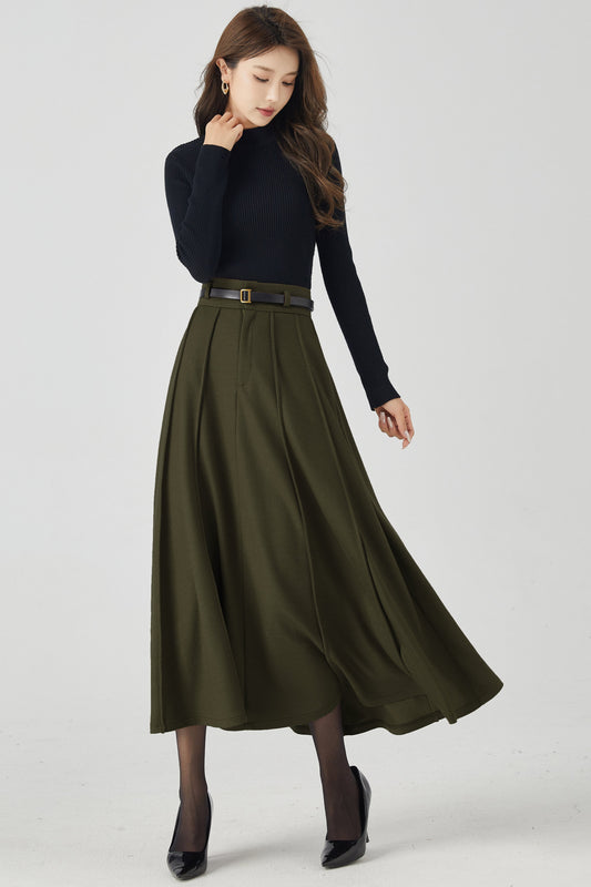 Woman wearing a black turtleneck and green skirt on a white background