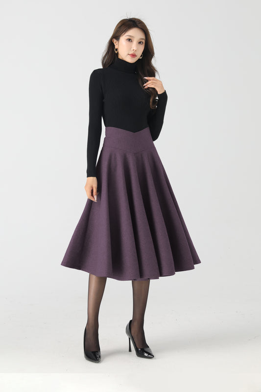 Woman wearing a black turtleneck and purple skirt on a white background