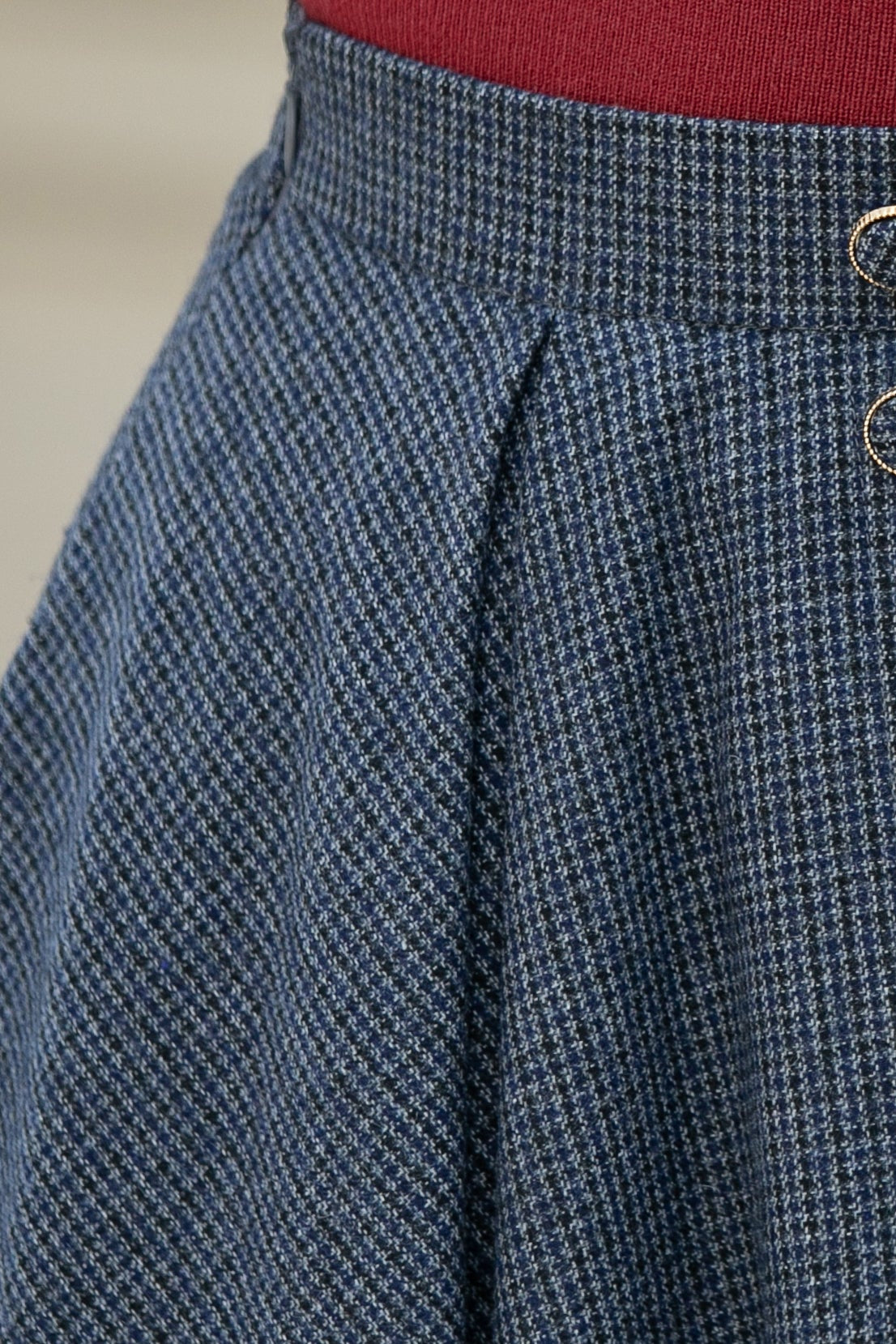 Close-up of blue houndstooth patterned pants with a blurred background