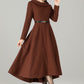 Model in brown wool‑blend high‑low midi dress with wide fold‑over collar