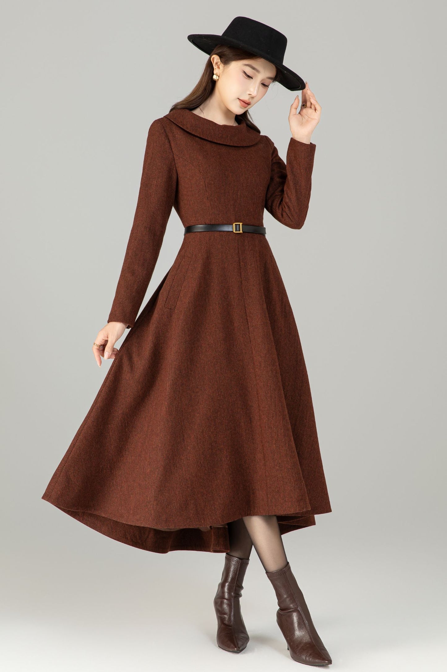 Model in brown wool‑blend high‑low midi dress with wide fold‑over collar