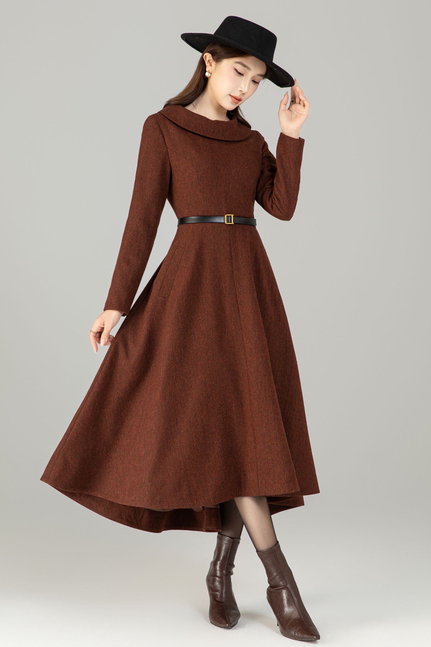 Model in brown wool‑blend high‑low midi dress with wide fold‑over collar