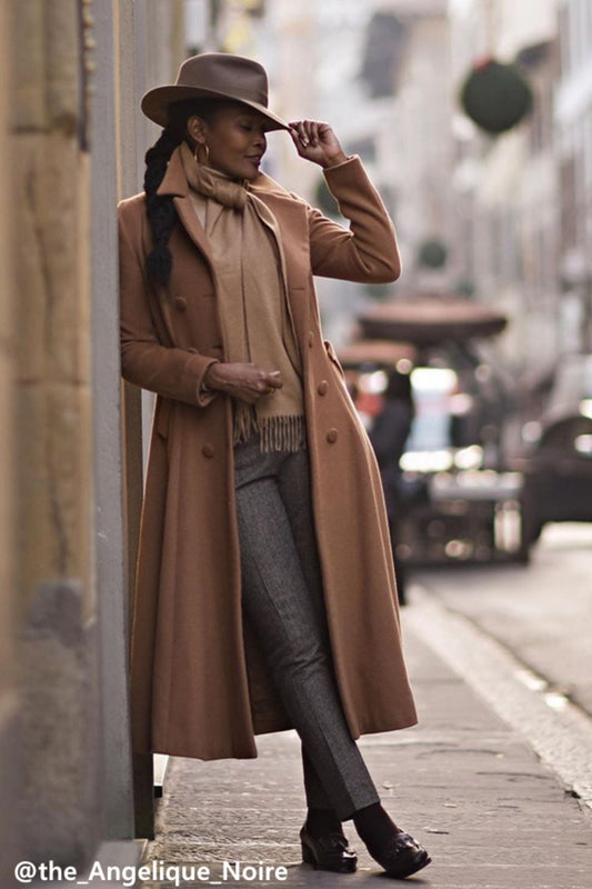 Woman wearing camel wool double-breasted coat on city street