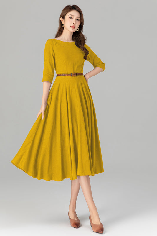 Woman wearing a mustard yellow dress on a gray background
