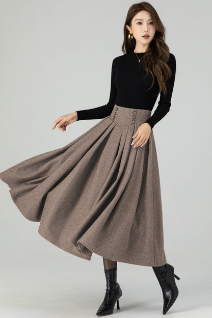 Woman wearing a black top and brown skirt on a white background