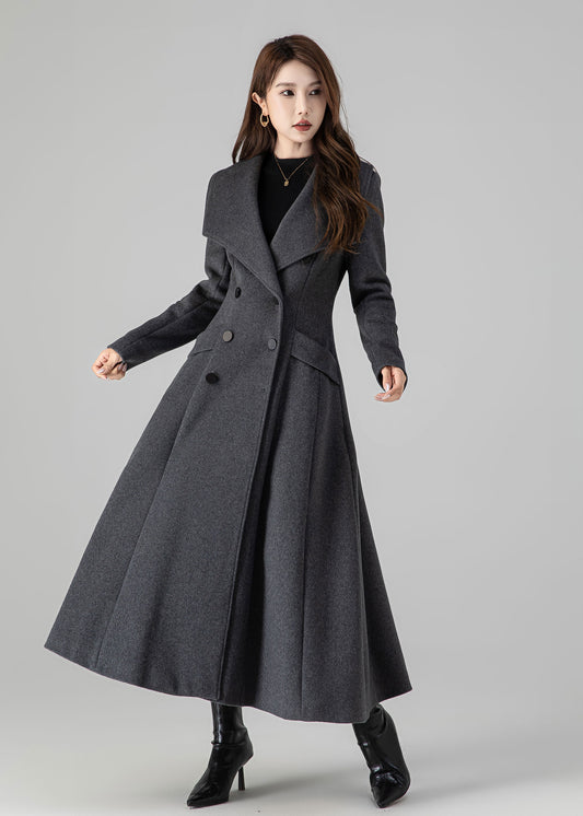 Woman wearing a long gray coat on a gray background