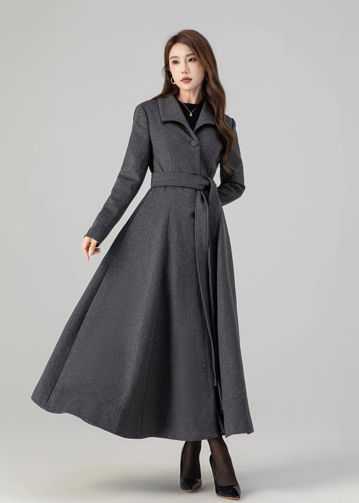 May include: A long gray coat with a belt and a single button closure. The coat has a flared skirt and a collar.