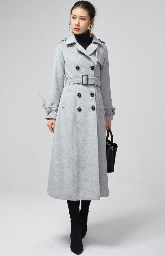 Woman wearing a handmade light gray wool double-breasted trench coat with tie belt by Xiaolizi