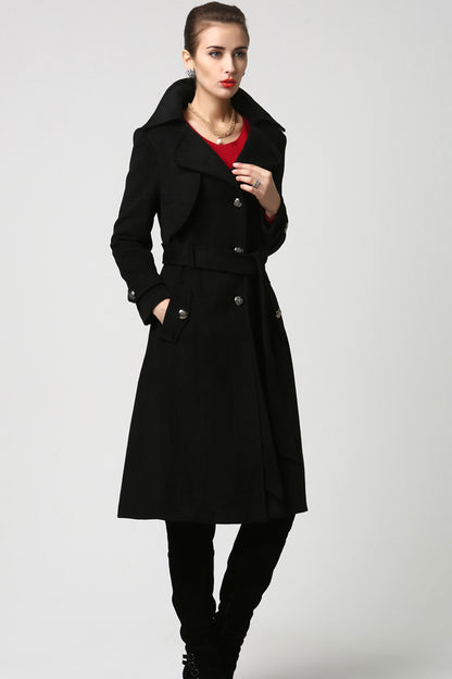 Woman wearing handmade wool trench coat in black with wide lapel collar