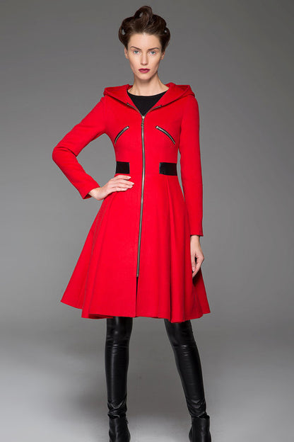 A model wearing a red hooded winter coat with leather stitching, long sleeves, and a zipper fastening through the front.