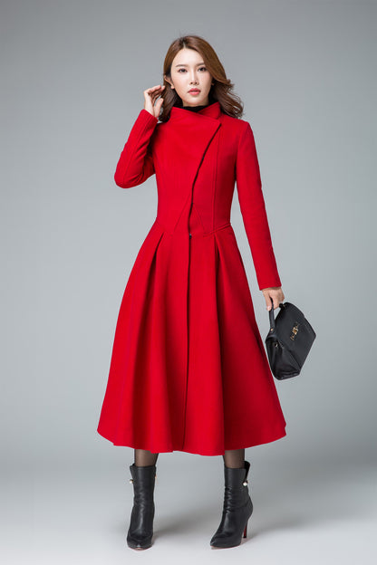 Model wearing a red asymmetrical wool coat with pleated midi skirt