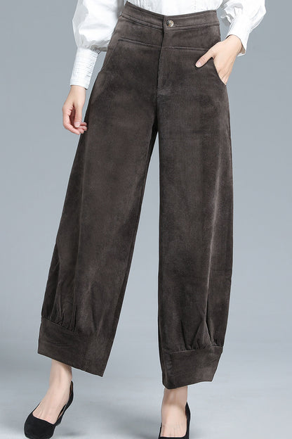 A pair of brown corduroy lantern pants with side pockets and a front zipper and button closure.
